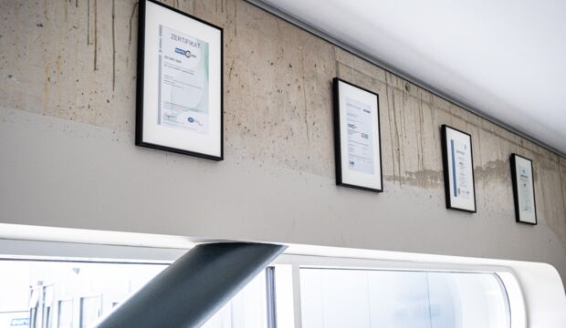 DIN ISO 9001 certifications hanging on the wall in the euro.COURIER administration building