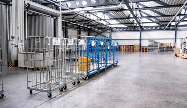 Various trolleys are available at the goods lock in the bright warehouse for receiving consignments